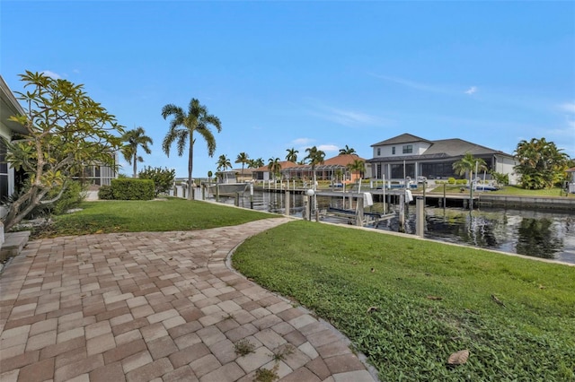 16 Tropicana Dr, Punta Gorda, FL 33950 - view of home's community featuring a water view, boat lift, a lawn, a dock, and a residential view