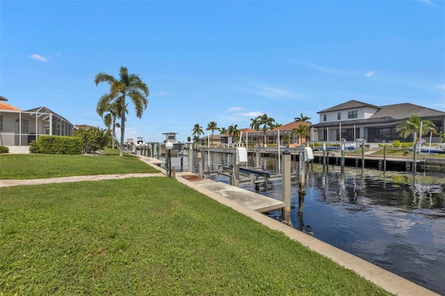 16 Tropicana Dr, Punta Gorda, FL 33950 - dock featuring boat lift, a water view, a lawn, and a residential view