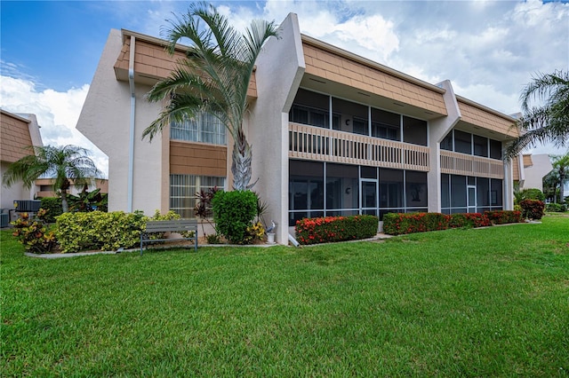 1080 Bal Harbor Blvd Unit 5B, Punta Gorda, FL 33950 - rear view of property with a yard and stucco siding