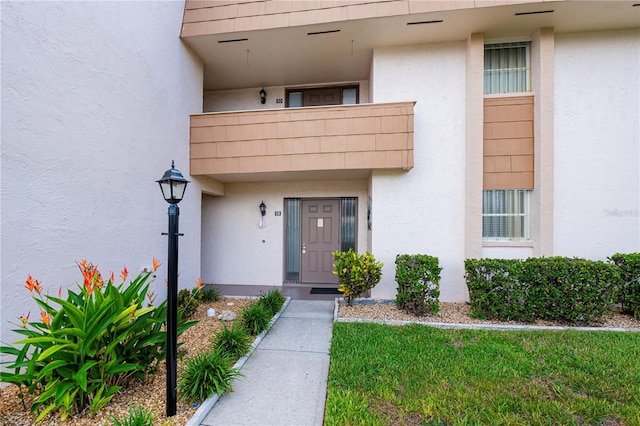 1080 Bal Harbor Blvd Unit 5B, Punta Gorda, FL 33950 - view of exterior entry with stucco siding and a balcony