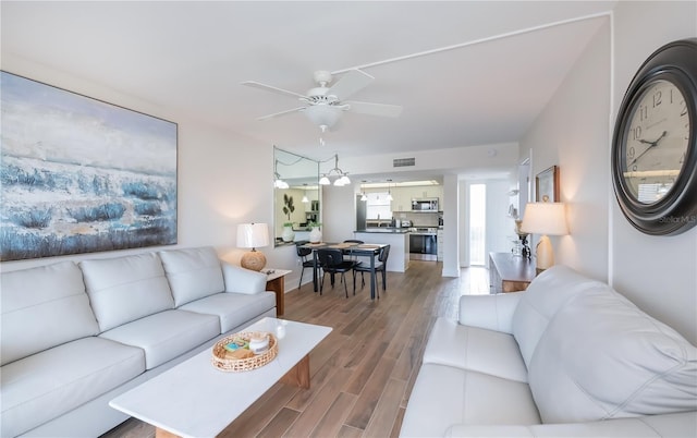 1080 Bal Harbor Blvd Unit 5B, Punta Gorda, FL 33950 - living area featuring a ceiling fan and wood finished floors