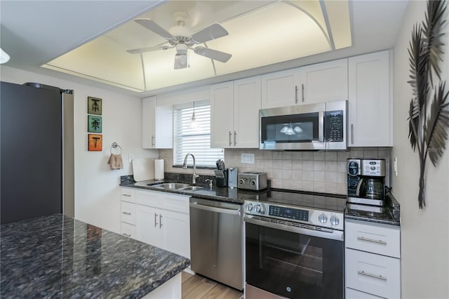 1080 Bal Harbor Blvd Unit 5B, Punta Gorda, FL 33950 - kitchen with appliances with stainless steel finishes, a tray ceiling, and white cabinetry