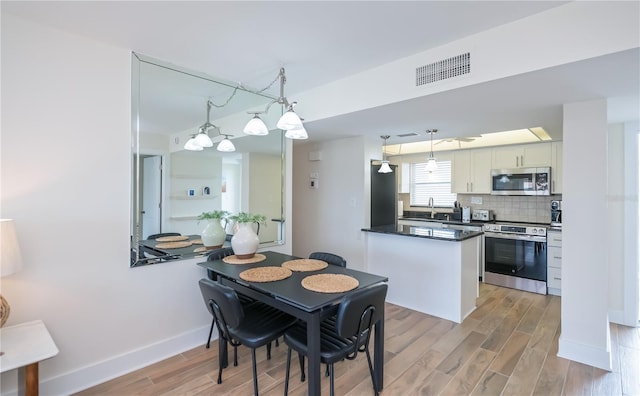 1080 Bal Harbor Blvd Unit 5B, Punta Gorda, FL 33950 - dining area with light wood-type flooring and baseboards