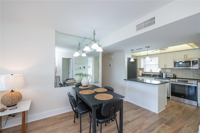 1080 Bal Harbor Blvd Unit 5B, Punta Gorda, FL 33950 - dining space featuring wood finished floors and baseboards