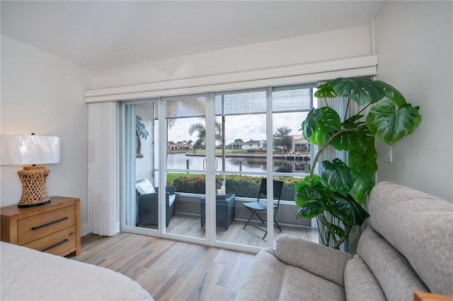 1080 Bal Harbor Blvd Unit 5B, Punta Gorda, FL 33950 - bedroom featuring a water view, light wood finished floors, access to outside, and french doors