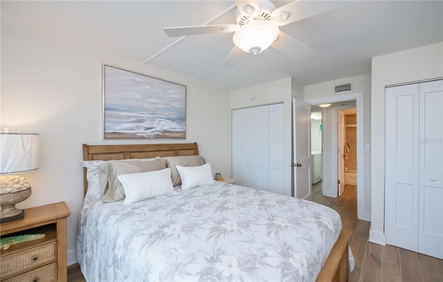1080 Bal Harbor Blvd Unit 5B, Punta Gorda, FL 33950 - bedroom with two closets, wood finished floors, and a ceiling fan