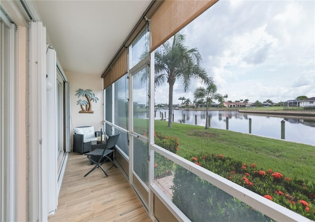 1080 Bal Harbor Blvd Unit 5B, Punta Gorda, FL 33950 - sunroom featuring a water view and wood finished floors