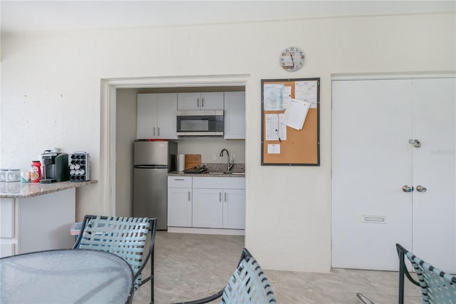 1080 Bal Harbor Blvd Unit 5B, Punta Gorda, FL 33950 - kitchen with stainless steel appliances and light stone countertops