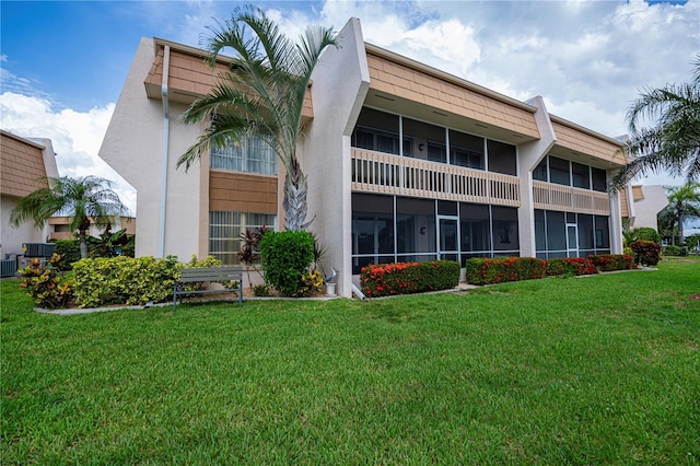 1080 Bal Harbor Blvd Unit 5B, Punta Gorda, FL 33950 - back of house featuring a lawn and stucco siding