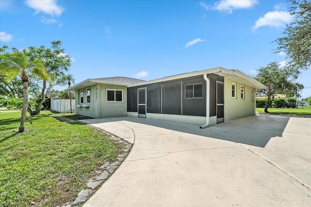 740 Dobell Ter NW, Port Charlotte, FL 33948 - back of property featuring a sunroom and concrete driveway