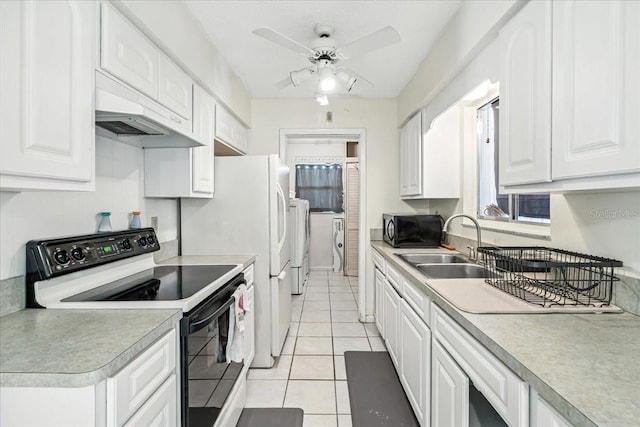 740 Dobell Ter NW, Port Charlotte, FL 33948 - kitchen with black range with electric stovetop, white cabinetry, ceiling fan, and light tile patterned flooring