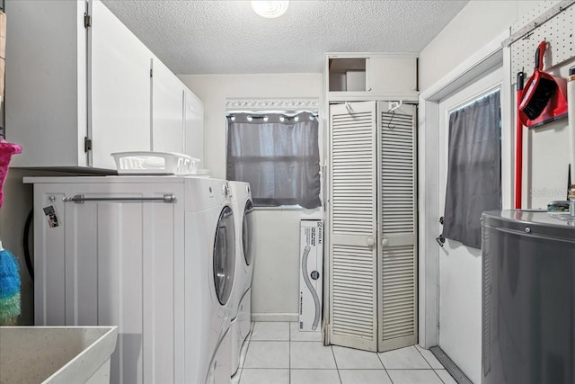 740 Dobell Ter NW, Port Charlotte, FL 33948 - washroom with independent washer and dryer, cabinet space, light tile patterned flooring, and a textured ceiling