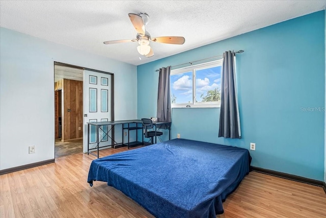 740 Dobell Ter NW, Port Charlotte, FL 33948 - bedroom featuring wood finished floors, billiards table, ceiling fan, and a textured ceiling