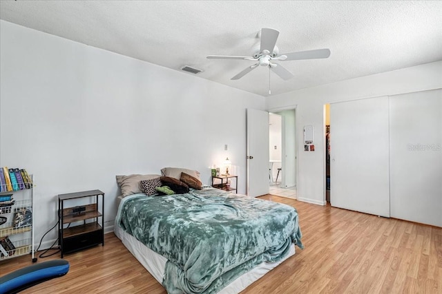 740 Dobell Ter NW, Port Charlotte, FL 33948 - bedroom featuring wood finished floors, a ceiling fan, a textured ceiling, and a closet