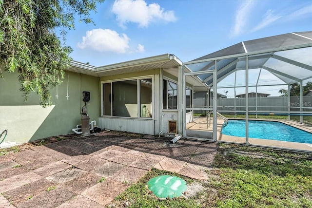 740 Dobell Ter NW, Port Charlotte, FL 33948 - back of house with a patio, glass enclosure, and stucco siding