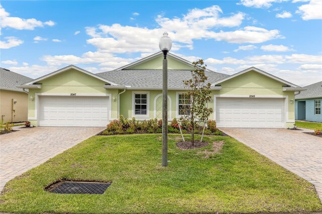 2047 Royal Tern Cir, Punta Gorda, FL 33983 - ranch-style house with an attached garage, stucco siding, driveway, and a front yard