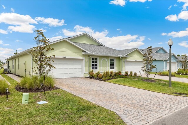 2047 Royal Tern Cir, Punta Gorda, FL 33983 - single story home featuring a garage, decorative driveway, stucco siding, and a front yard