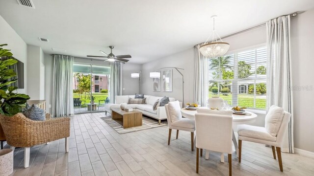 2047 Royal Tern Cir, Punta Gorda, FL 33983 - dining area with healthy amount of natural light, wood finished floors, a chandelier, and ceiling fan