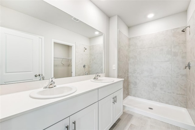 2047 Royal Tern Cir, Punta Gorda, FL 33983 - full bathroom featuring double vanity, a tile shower, and a walk in closet