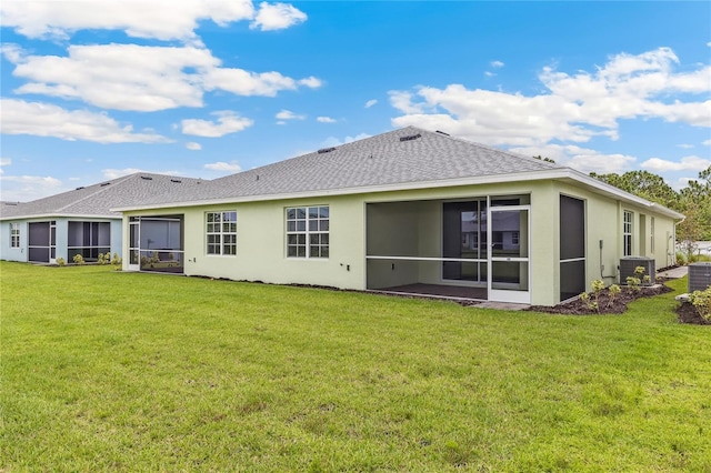 2047 Royal Tern Cir, Punta Gorda, FL 33983 - rear view of house with a sunroom, a shingled roof, stucco siding, and a yard
