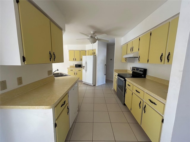 4222 Cockrell St, Port Charlotte, FL 33948 - kitchen with white appliances, under cabinet range hood, ceiling fan, light tile patterned floors, and light countertops