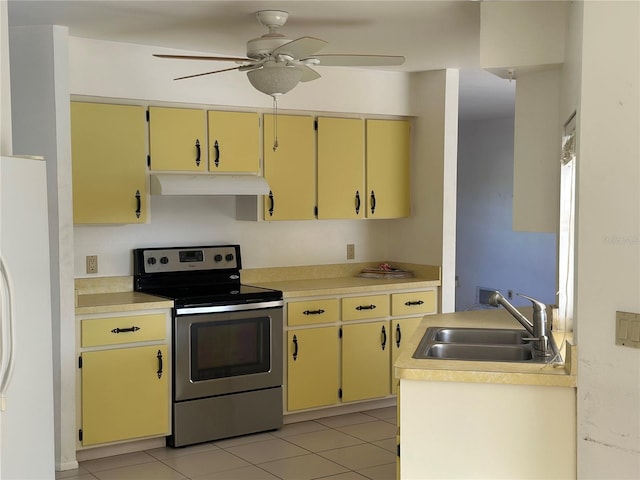 4222 Cockrell St, Port Charlotte, FL 33948 - kitchen with stainless steel electric range oven, under cabinet range hood, freestanding refrigerator, and cream cabinets