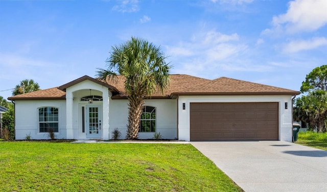 2399 Redstone Ave, North Port, FL 34288 - ranch-style home with stucco siding, driveway, a garage, and a front yard