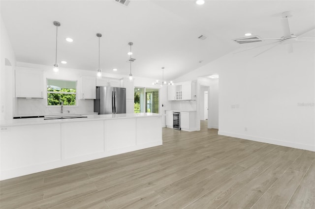 2399 Redstone Ave, North Port, FL 34288 - unfurnished living room featuring recessed lighting, healthy amount of natural light, light wood-type flooring, beverage cooler, and lofted ceiling
