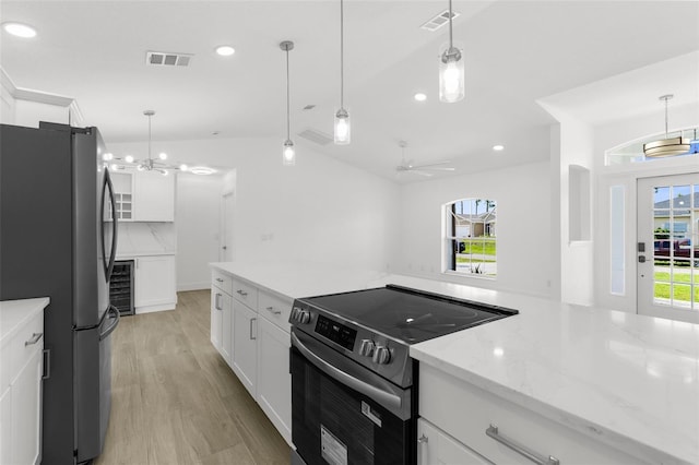 2399 Redstone Ave, North Port, FL 34288 - kitchen with stainless steel appliances, light wood-style flooring, white cabinetry, recessed lighting, and light stone counters
