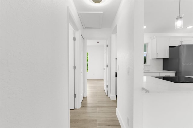 2399 Redstone Ave, North Port, FL 34288 - hallway with baseboards and light wood-style floors