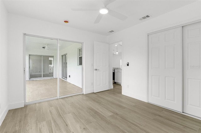 2399 Redstone Ave, North Port, FL 34288 - unfurnished bedroom featuring light wood-style floors, connected bathroom, a closet, and a ceiling fan