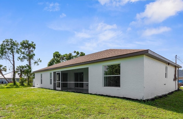 2399 Redstone Ave, North Port, FL 34288 - back of property with stucco siding and a lawn