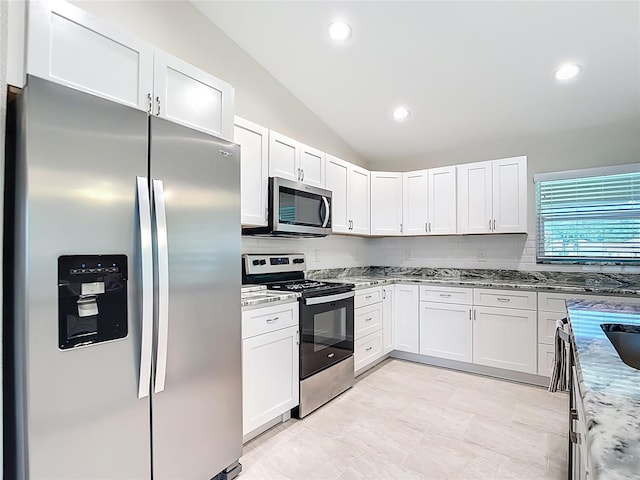 5493 Jody Ave, North Port, FL 34288 - kitchen with stainless steel appliances, lofted ceiling, light stone countertops, white cabinets, and recessed lighting