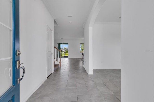 17395 Palmetto Pass Ln, Punta Gorda, FL 33982 - foyer featuring arched walkways, stairway, and crown molding