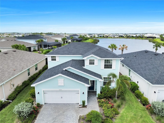 17395 Palmetto Pass Ln, Punta Gorda, FL 33982 - view of front of property with a shingled roof, decorative driveway, a water view, a garage, and a residential view