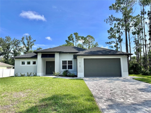 4748 Sylvania Ave, North Port, FL 34286 - view of front facade with stucco siding, decorative driveway, a garage, and roof with shingles
