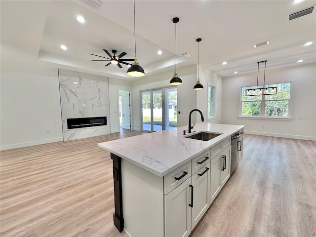 4748 Sylvania Ave, North Port, FL 34286 - kitchen with open floor plan, stainless steel dishwasher, light wood-style flooring, decorative light fixtures, and recessed lighting