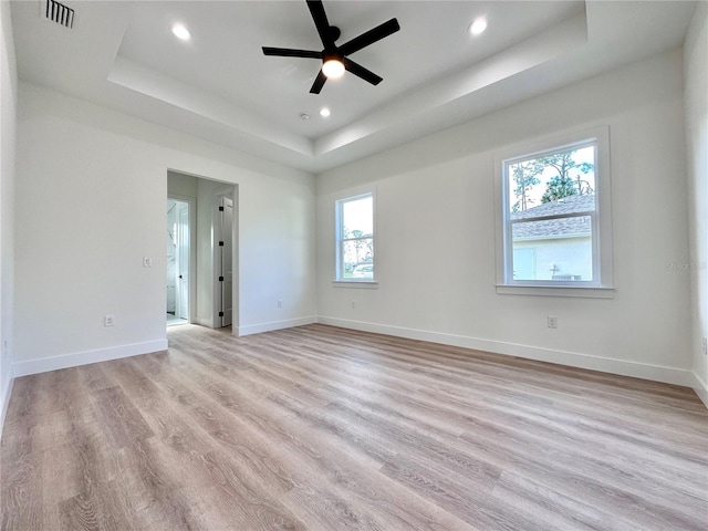4748 Sylvania Ave, North Port, FL 34286 - spare room featuring a tray ceiling, healthy amount of natural light, light wood finished floors, recessed lighting, and a ceiling fan