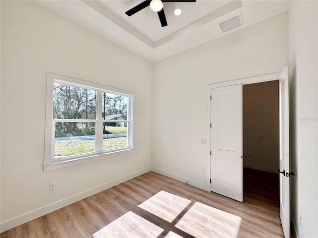 4748 Sylvania Ave, North Port, FL 34286 - spare room featuring light wood-style floors, ceiling fan, and a raised ceiling