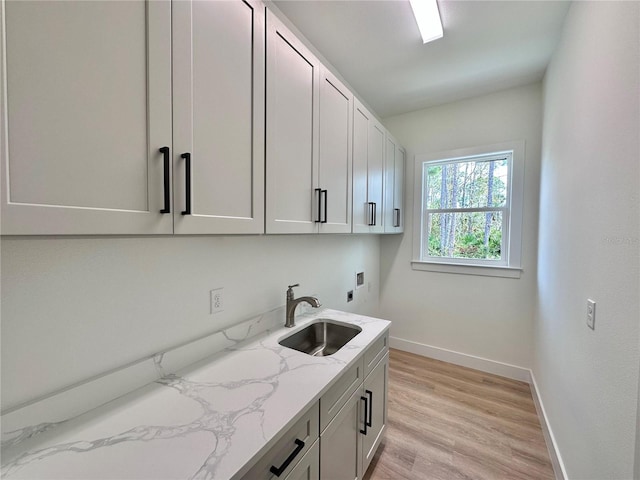 4748 Sylvania Ave, North Port, FL 34286 - laundry room with cabinet space, electric dryer hookup, light wood-type flooring, and hookup for a washing machine