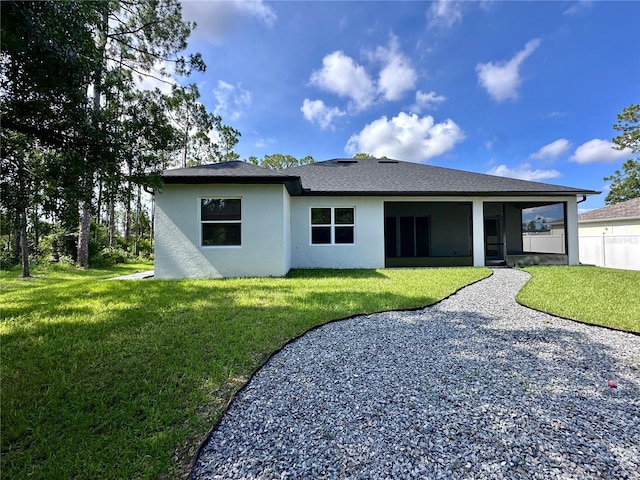 4748 Sylvania Ave, North Port, FL 34286 - rear view of house featuring a yard, stucco siding, and a sunroom