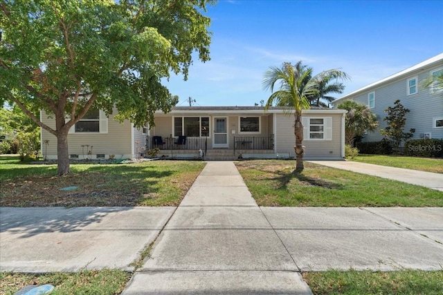 315 Durrance St, Punta Gorda, FL 33950 - ranch-style house with covered porch and a front yard