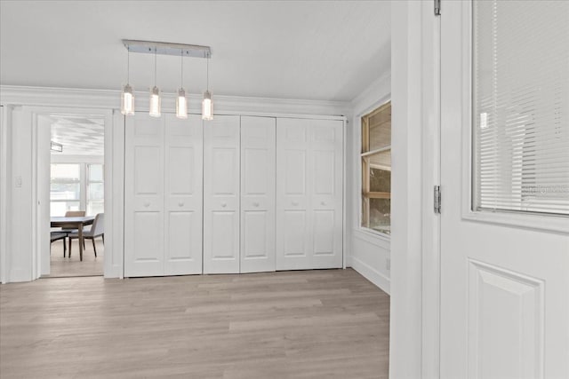 315 Durrance St, Punta Gorda, FL 33950 - unfurnished dining area featuring light wood-style flooring and crown molding
