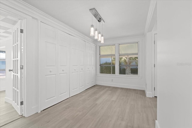 315 Durrance St, Punta Gorda, FL 33950 - unfurnished bedroom featuring crown molding, light wood-style floors, multiple windows, and a closet