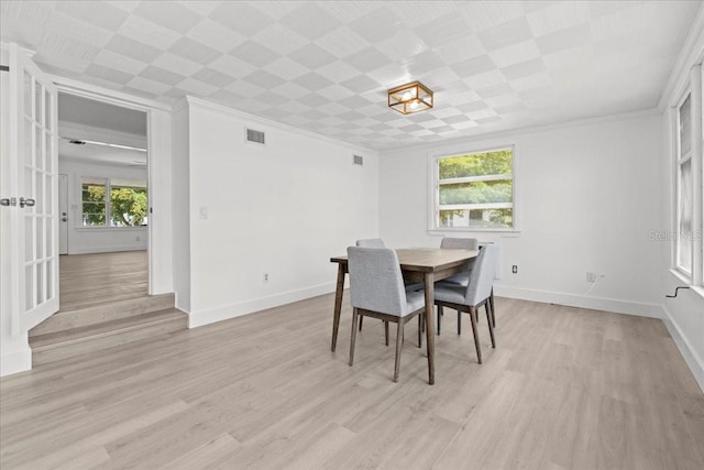 315 Durrance St, Punta Gorda, FL 33950 - dining area featuring light wood-style flooring and crown molding