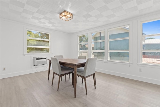 315 Durrance St, Punta Gorda, FL 33950 - dining space featuring crown molding, light wood-style flooring, plenty of natural light, and an AC wall unit
