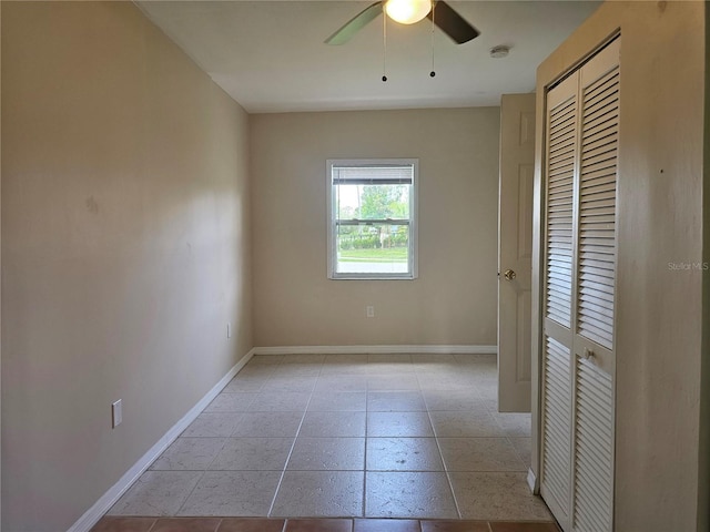 21552 Holdern Ave, Port Charlotte, FL 33952 - unfurnished bedroom with a closet, a ceiling fan, and light tile patterned flooring