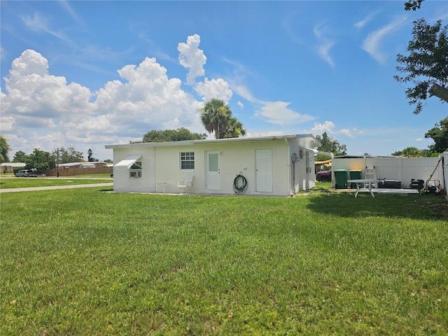 21552 Holdern Ave, Port Charlotte, FL 33952 - rear view of house featuring a lawn and stucco siding