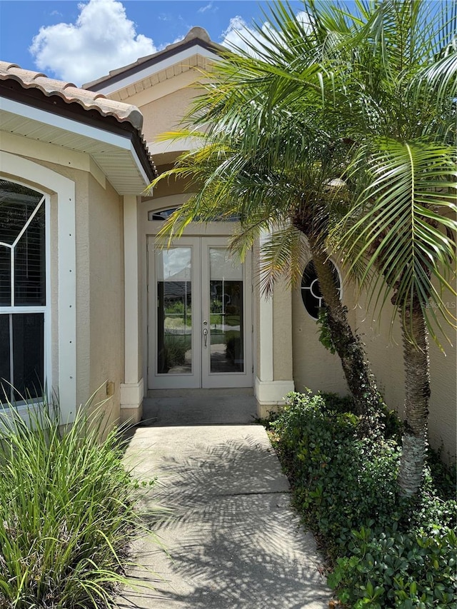 2760 Royal Palm Dr, North Port, FL 34288 - doorway to property featuring french doors and stucco siding