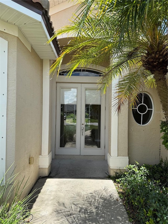 2760 Royal Palm Dr, North Port, FL 34288 - entrance to property with french doors and stucco siding